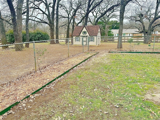 view of yard with an outdoor structure and fence