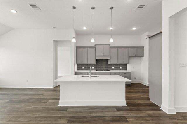 7221 Ladybug, Little Elm, TX 76227 - kitchen with gray cabinetry, decorative backsplash, light countertops, an island with sink, and a sink