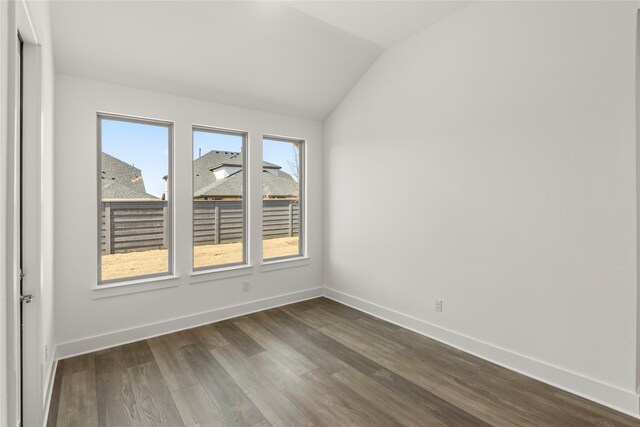 7221 Ladybug, Little Elm, TX 76227 - unfurnished room featuring lofted ceiling, dark wood-type flooring, and baseboards