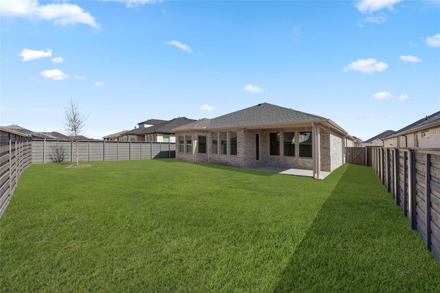 7221 Ladybug, Little Elm, TX 76227 - rear view of house with brick siding, a patio, and roof with shingles