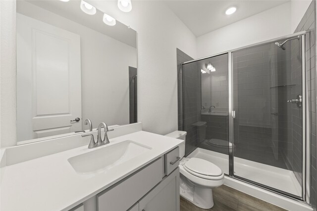 7221 Ladybug, Little Elm, TX 76227 - full bath featuring toilet, a stall shower, vanity, wood finished floors, and recessed lighting