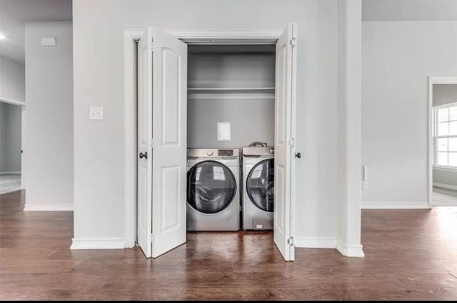 clothes washing area featuring washing machine and dryer and dark hardwood / wood-style floors