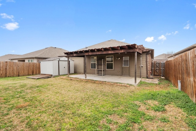 rear view of property with a storage shed, a lawn, and a patio area