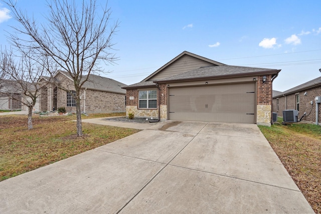 ranch-style house with a garage, a front yard, and central air condition unit