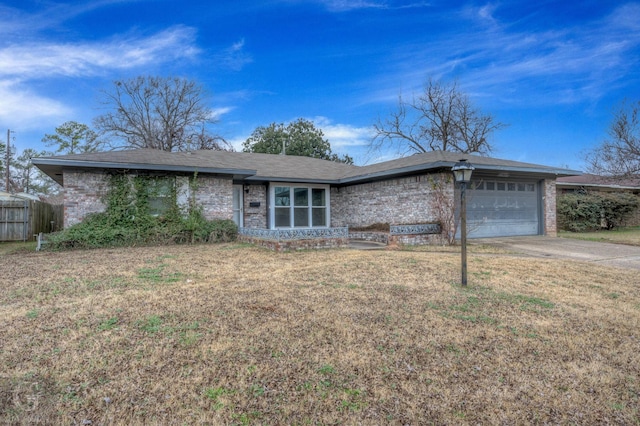 ranch-style house with a garage and a front yard