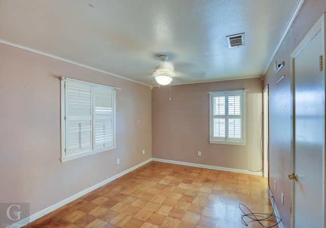 unfurnished room with ceiling fan, crown molding, light parquet flooring, and a textured ceiling