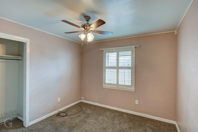 unfurnished bedroom with crown molding, ceiling fan, carpet flooring, and a closet