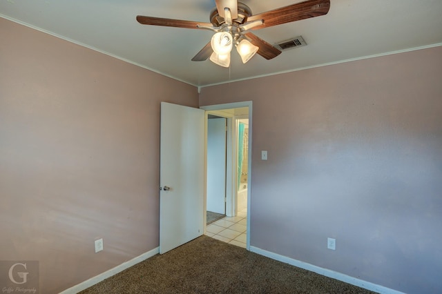 carpeted empty room featuring crown molding and ceiling fan