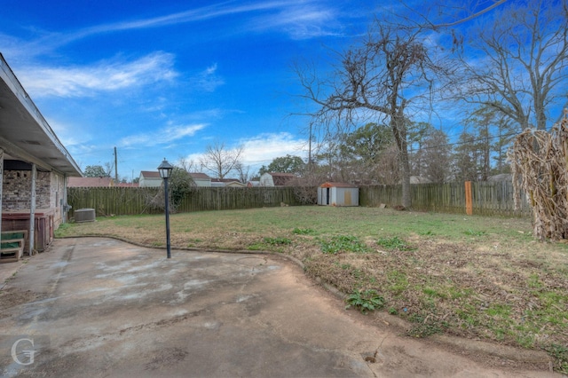 view of yard with a shed, cooling unit, and a patio area