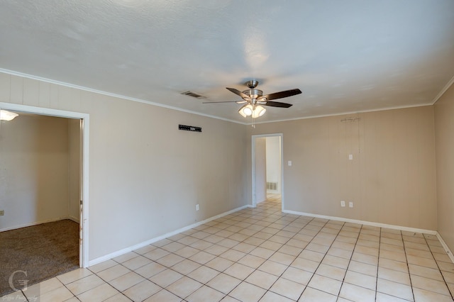 tiled empty room with crown molding and ceiling fan