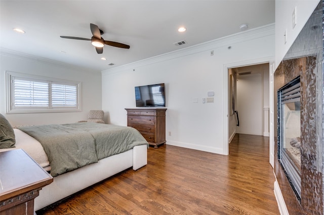 bedroom featuring hardwood / wood-style flooring, ceiling fan, and ornamental molding