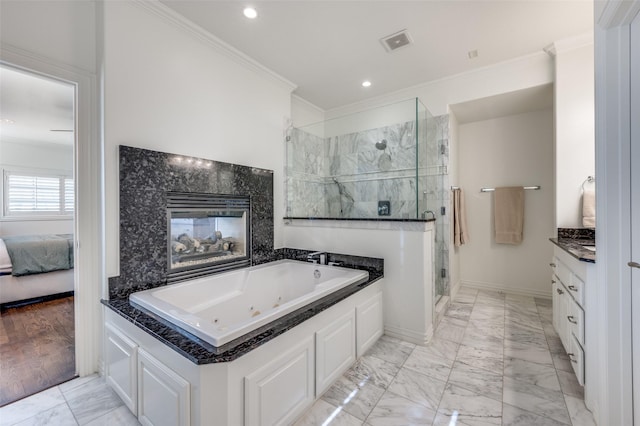 bathroom with ornamental molding, independent shower and bath, and vanity