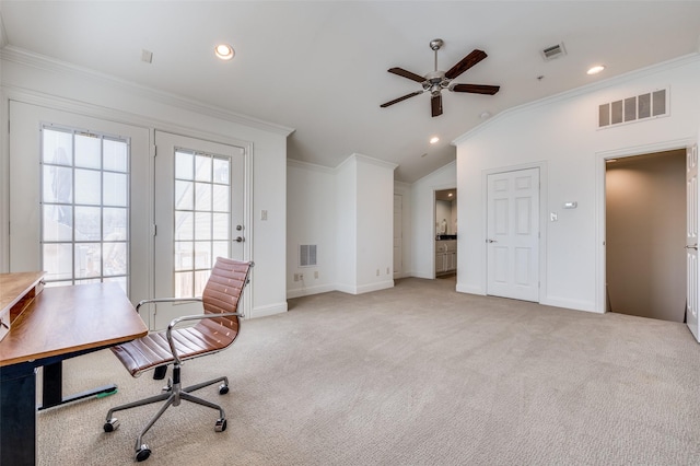 office space with ceiling fan, ornamental molding, vaulted ceiling, and light carpet