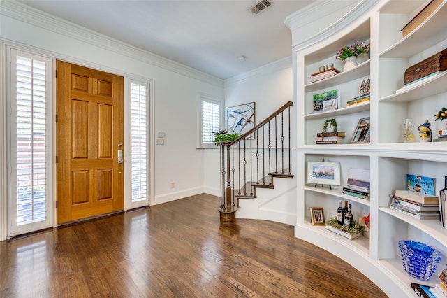 foyer featuring crown molding and dark hardwood / wood-style flooring