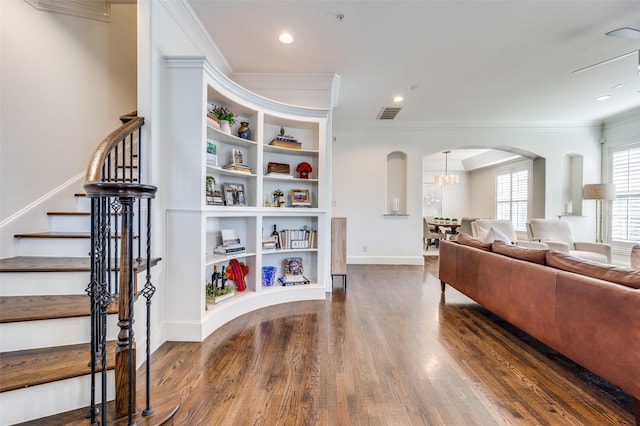 living room with ornamental molding, dark hardwood / wood-style floors, and built in features