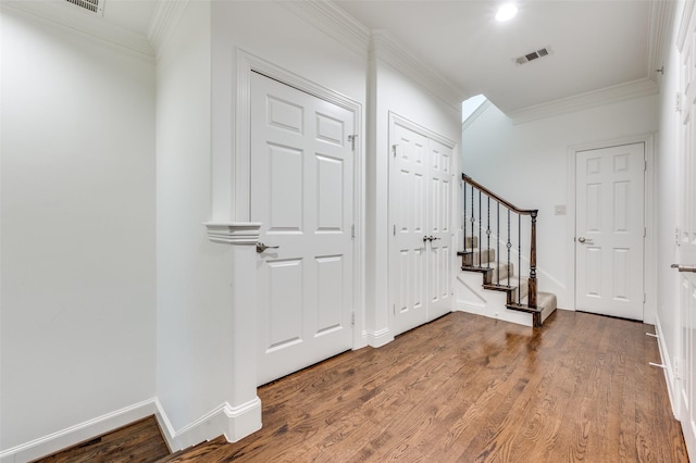 foyer with hardwood / wood-style flooring and ornamental molding