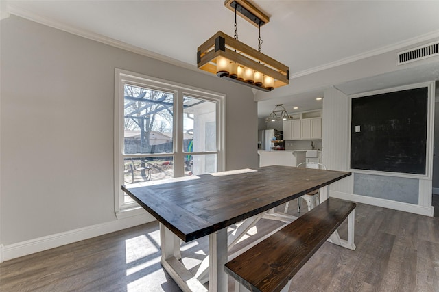 unfurnished dining area with ornamental molding, dark hardwood / wood-style floors, and an inviting chandelier