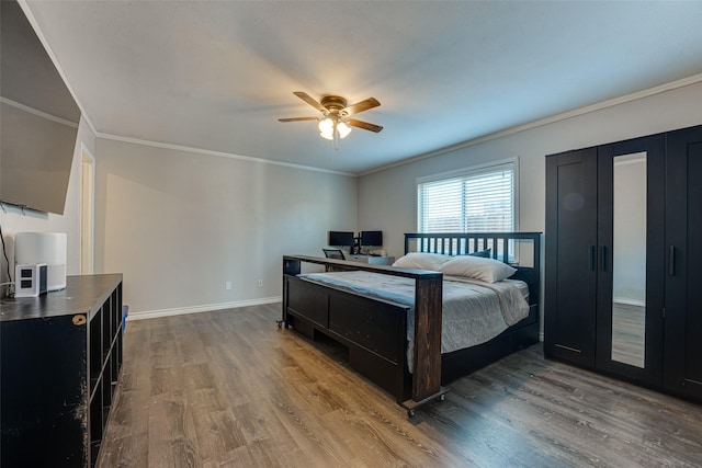 bedroom with crown molding, ceiling fan, and wood-type flooring