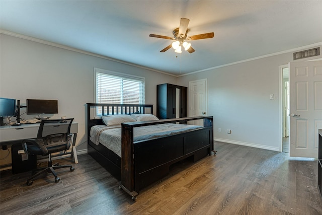 bedroom featuring ceiling fan, ornamental molding, and wood-type flooring