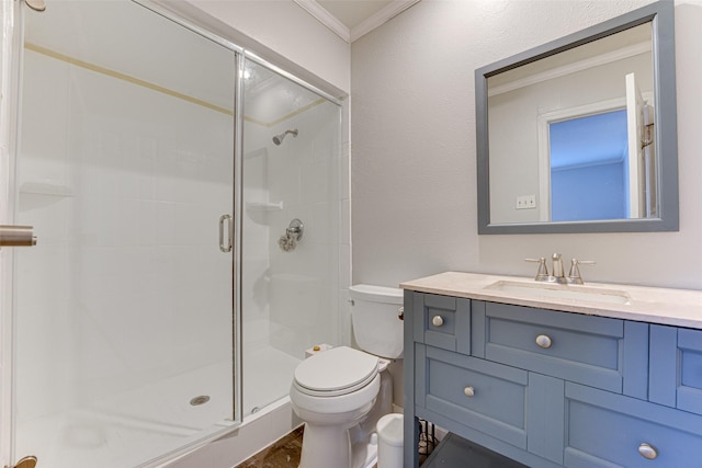 bathroom with vanity, crown molding, toilet, and walk in shower