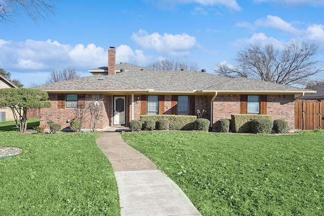 single story home featuring a front lawn