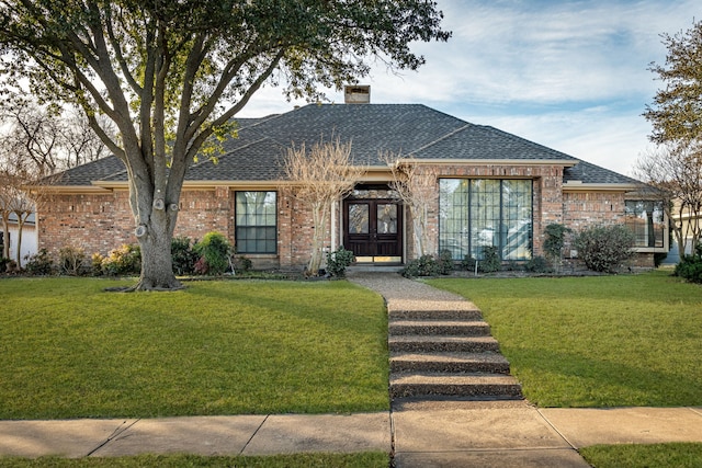 single story home with french doors and a front lawn