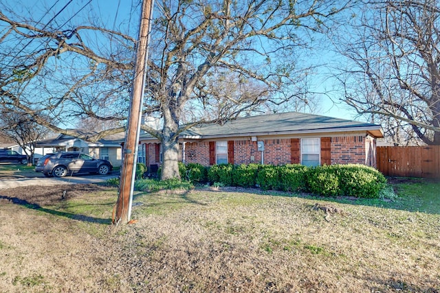 single story home featuring a front lawn and a carport