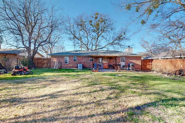 back of house featuring a yard, a patio, and central air condition unit