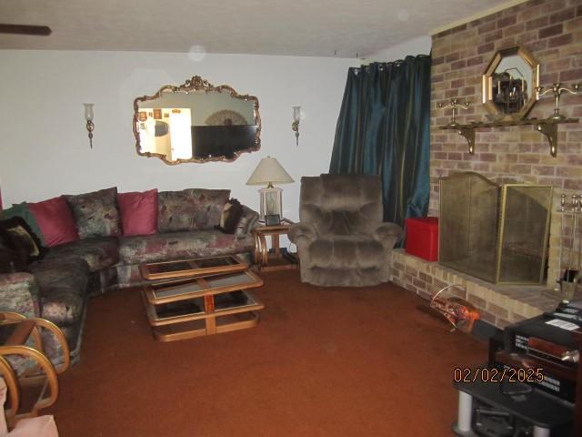 carpeted living room with a brick fireplace