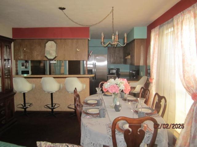 dining space featuring a chandelier