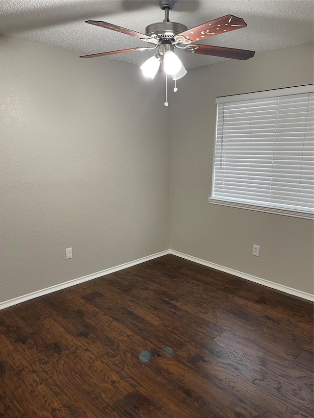 spare room with ceiling fan, dark hardwood / wood-style floors, and a textured ceiling