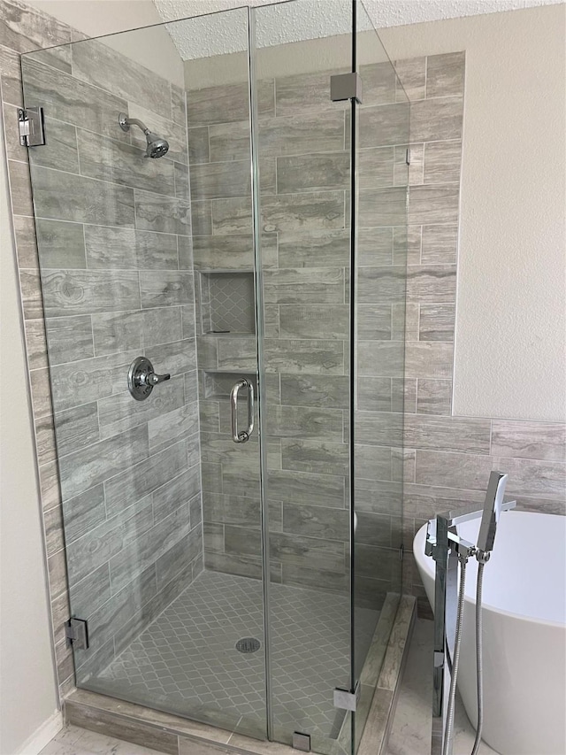 bathroom with separate shower and tub