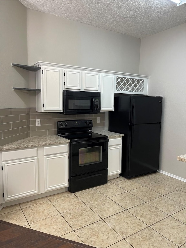 kitchen featuring white cabinets and black appliances