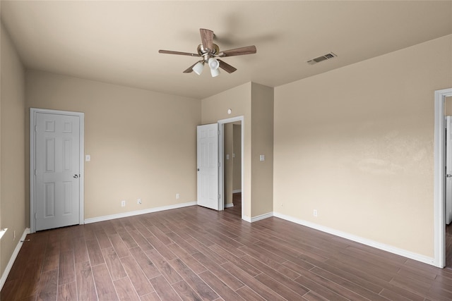 spare room featuring ceiling fan and dark hardwood / wood-style floors