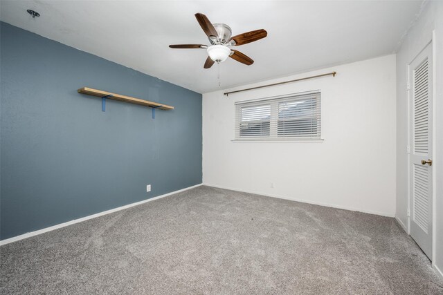 unfurnished bedroom featuring carpet, ceiling fan, and a closet