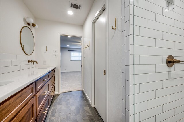 bathroom featuring tasteful backsplash and vanity