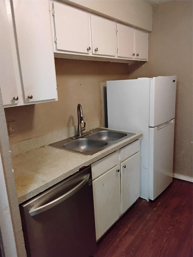 kitchen with sink, stainless steel dishwasher, dark hardwood / wood-style floors, and white cabinets