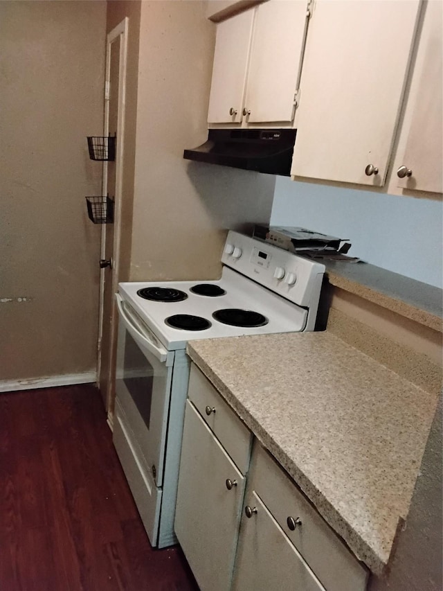 kitchen with white electric stove, white cabinetry, and dark wood-type flooring