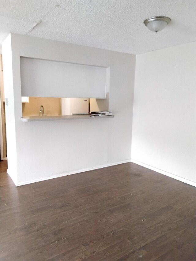 interior space with dark hardwood / wood-style floors and a textured ceiling