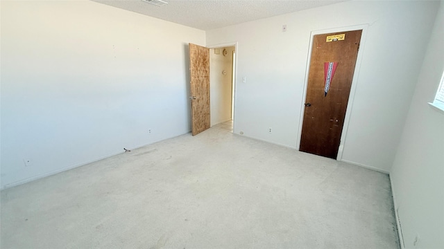 spare room with a textured ceiling