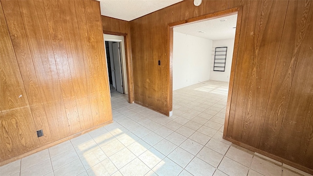 spare room featuring wooden walls