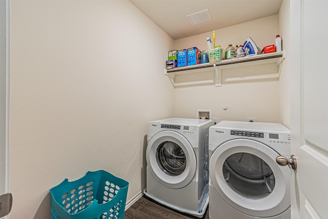 clothes washing area featuring washing machine and dryer and dark hardwood / wood-style floors