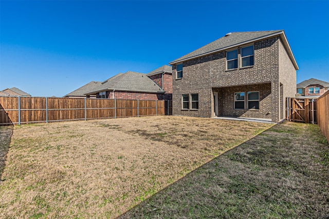 rear view of house with a yard