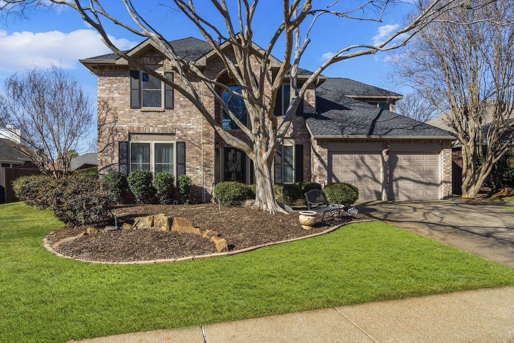 view of front of property featuring a garage and a front yard