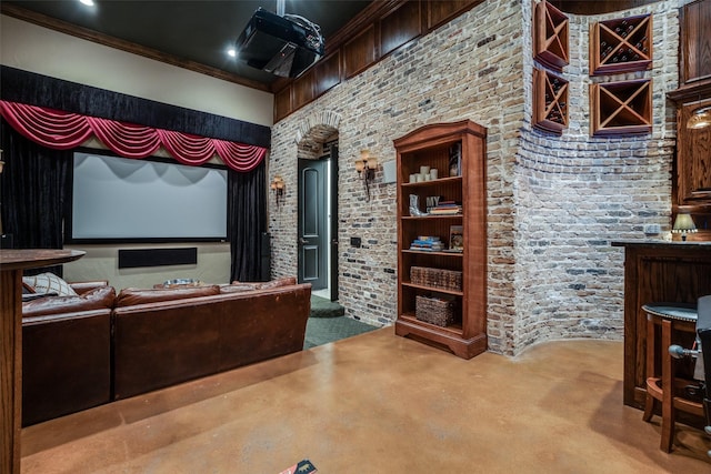 carpeted home theater room featuring ornamental molding