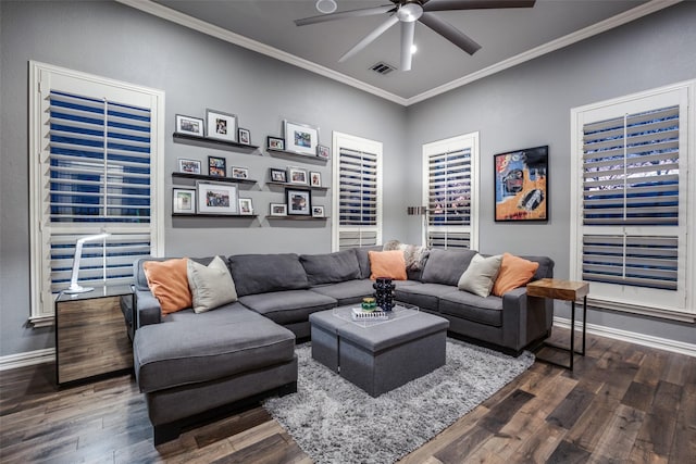 living room with dark wood-style flooring, baseboards, visible vents, a ceiling fan, and crown molding