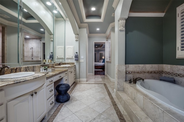 bathroom featuring tiled bath, crown molding, and vanity