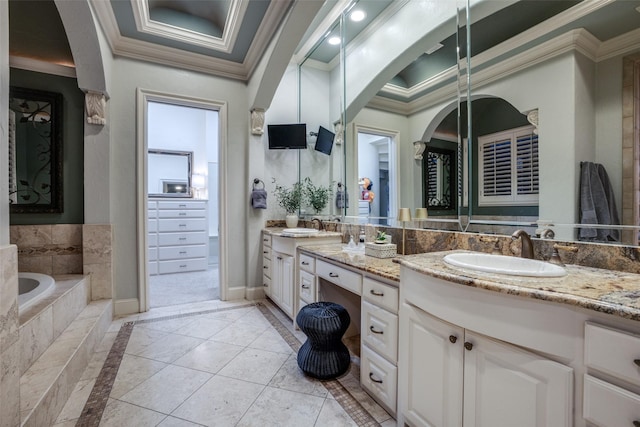 bathroom with tiled bath, tile patterned floors, vanity, and ornamental molding