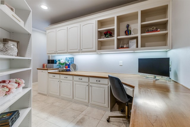 home office featuring light tile patterned flooring and built in study area