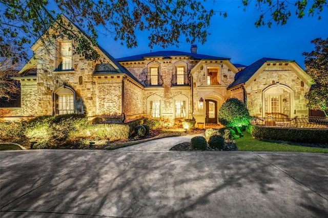 45 Dunrobin, Richardson, TX 75082 - french country inspired facade featuring stone siding and a chimney
